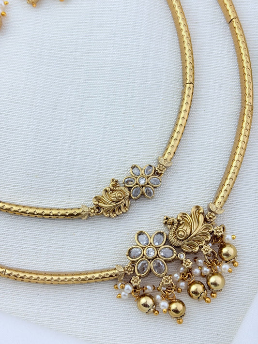 Classic layered necklace showcasing peacock and floral artistry, enriched with stones and highlighted pearl & gold drops