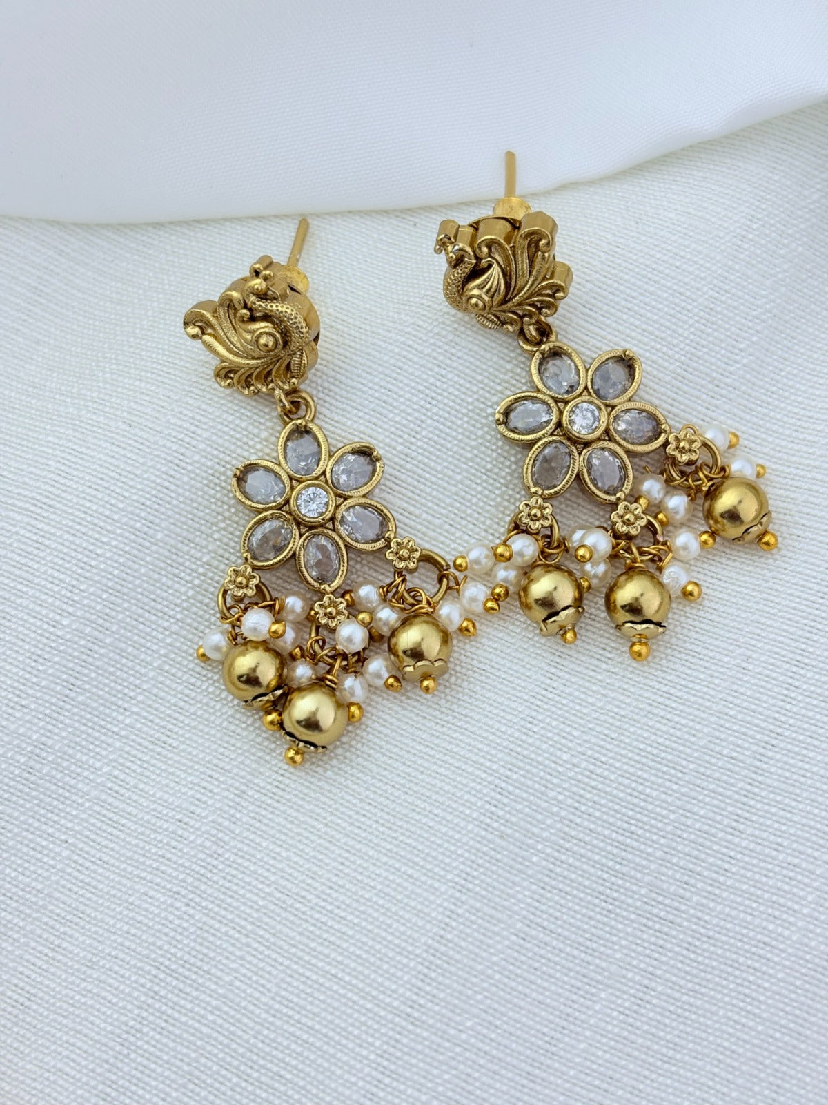 Classic layered necklace showcasing peacock and floral artistry, enriched with stones and highlighted pearl & gold drops