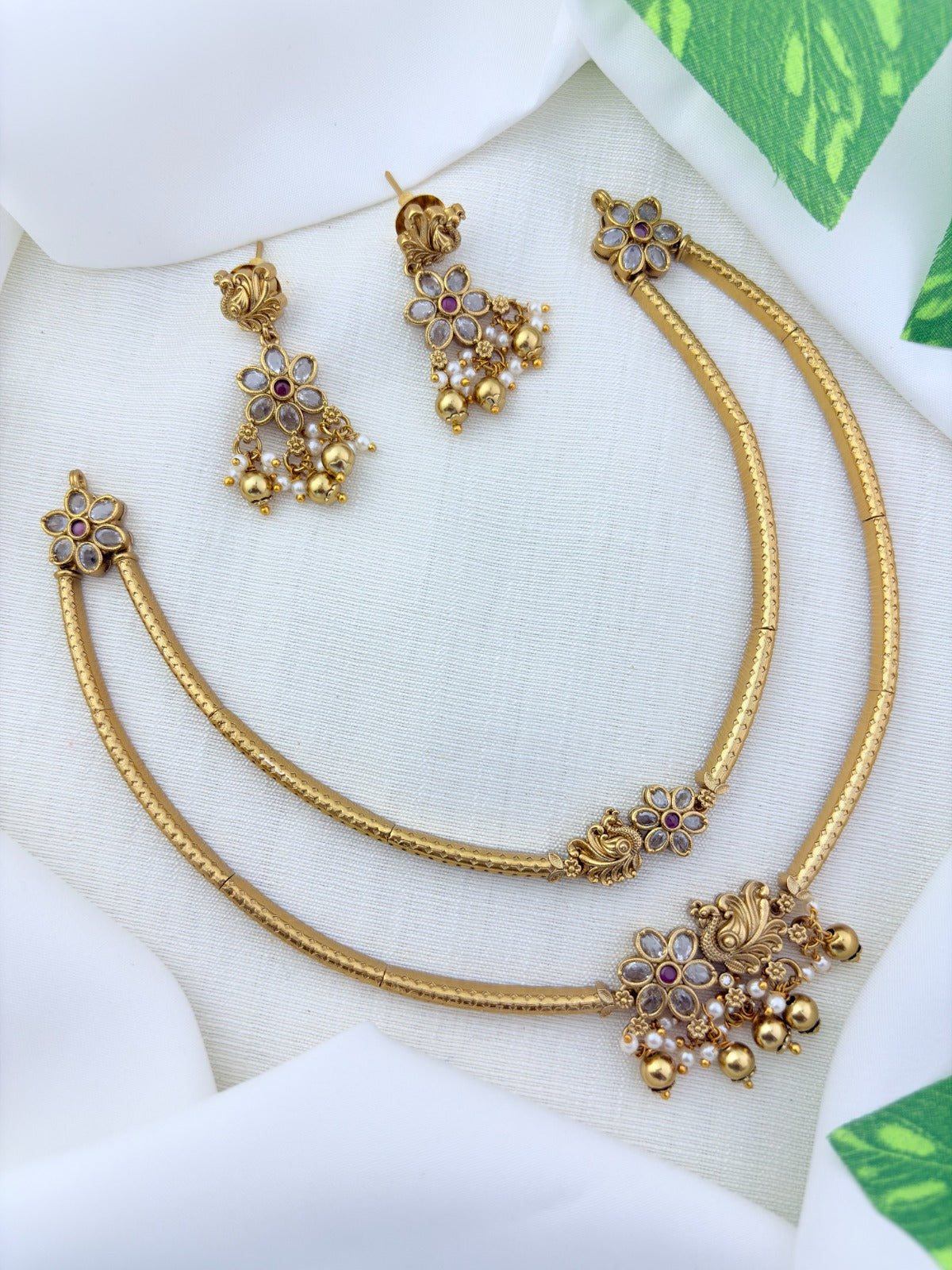 Classic layered necklace showcasing peacock and floral artistry, enriched with stones and highlighted pearl & gold drops