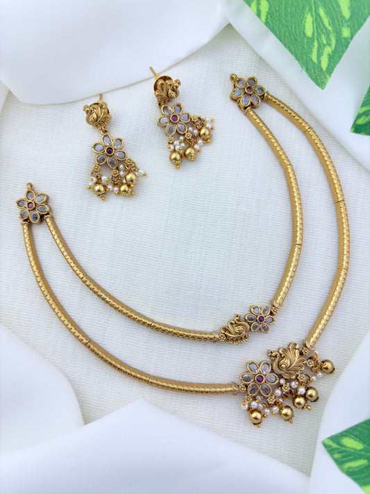 Classic layered necklace showcasing peacock and floral artistry, enriched with stones and highlighted pearl & gold drops