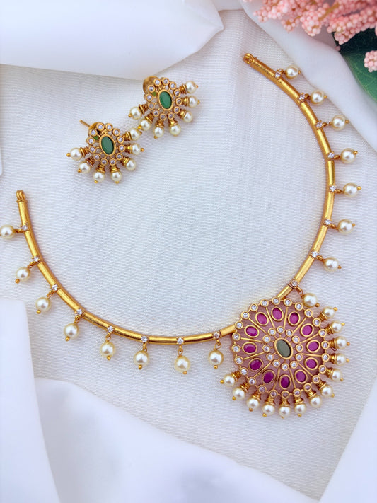 Premium matte finish necklace and earrings adorned with classic stones and pearl drops