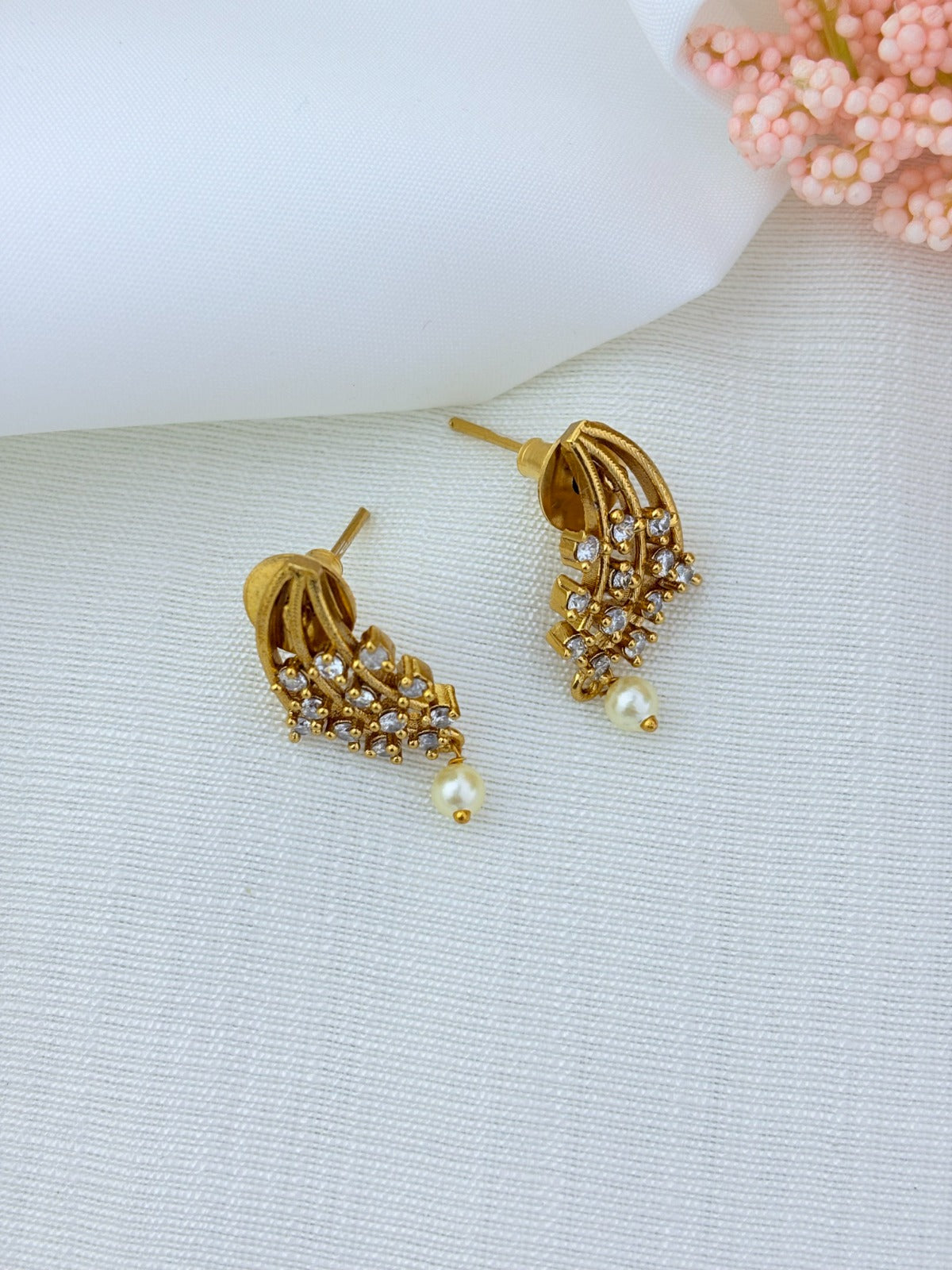 Premium matte finish necklace and earrings adorned with stones and pearl drops for a graceful appeal