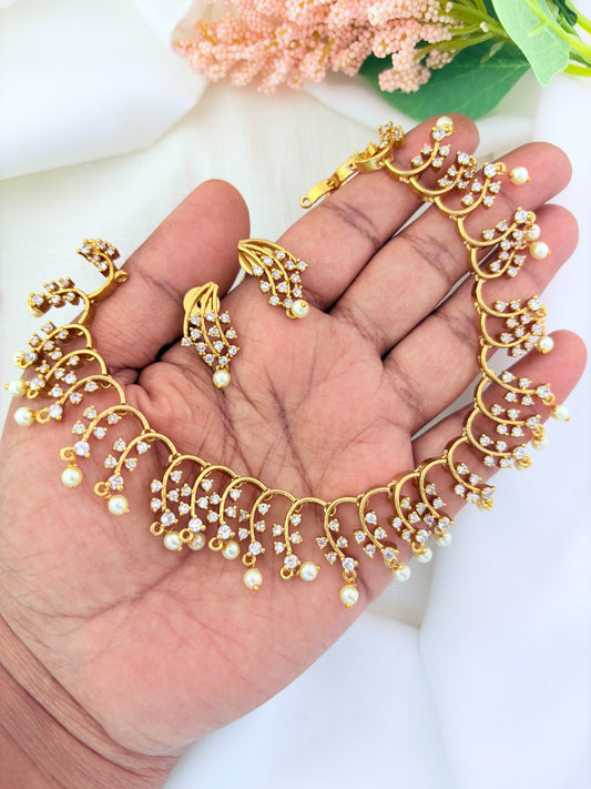 Premium matte finish necklace and earrings adorned with stones and pearl drops for a graceful appeal