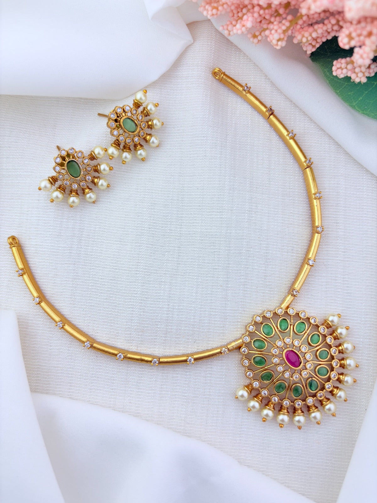 Premium matte finish necklace and earrings adorned with classic stones and pearls