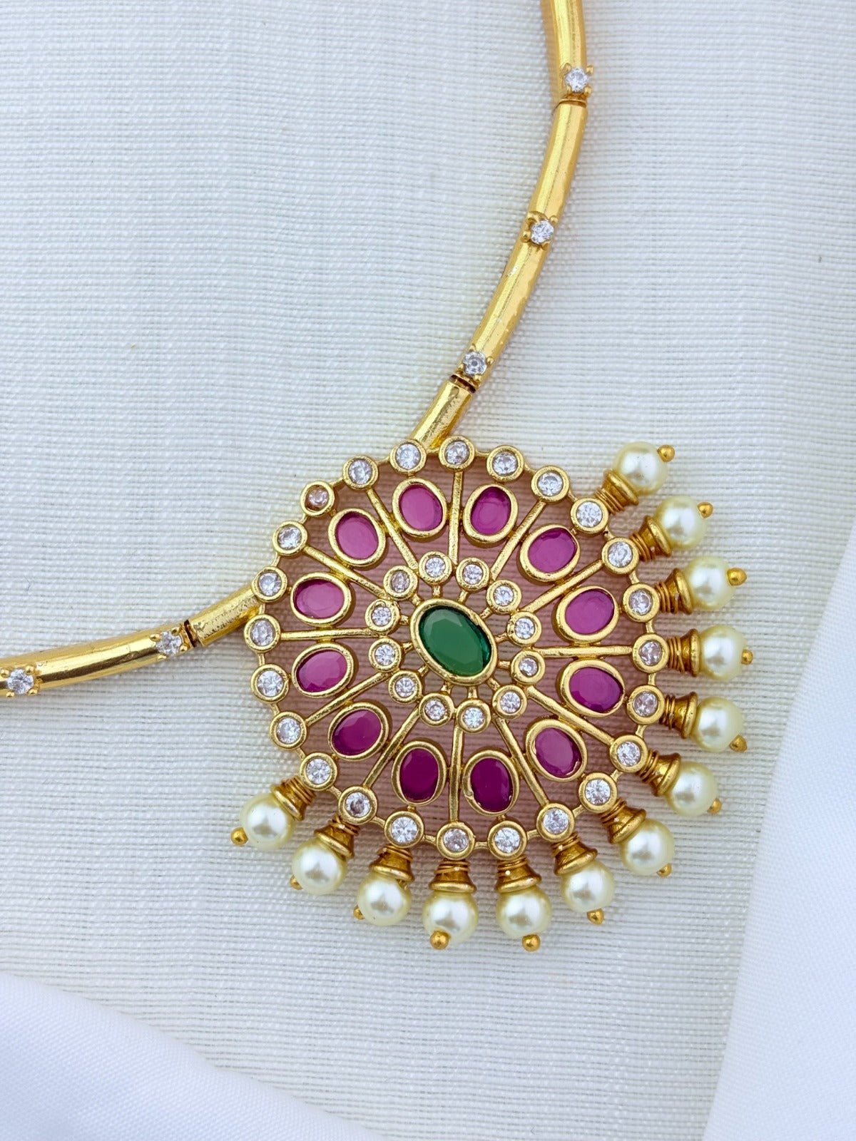 Premium matte finish necklace and earrings adorned with classic stones and pearls