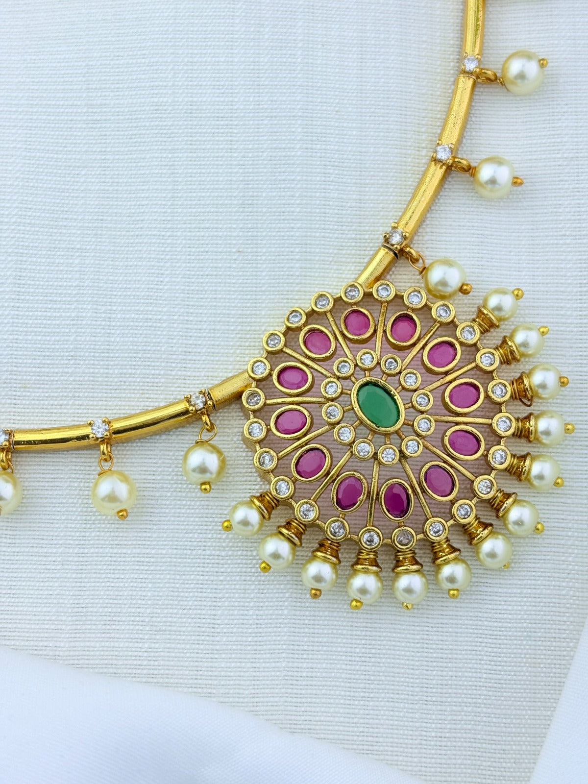 Premium matte finish necklace and earrings adorned with classic stones and pearl drops