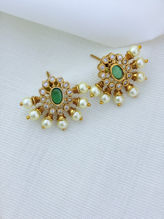 Premium matte finish necklace and earrings adorned with classic stones and pearl drops